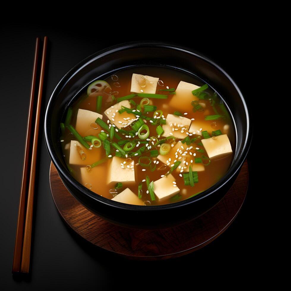 Food photography of Miso Soup on black bowl isolated on dark background. photo