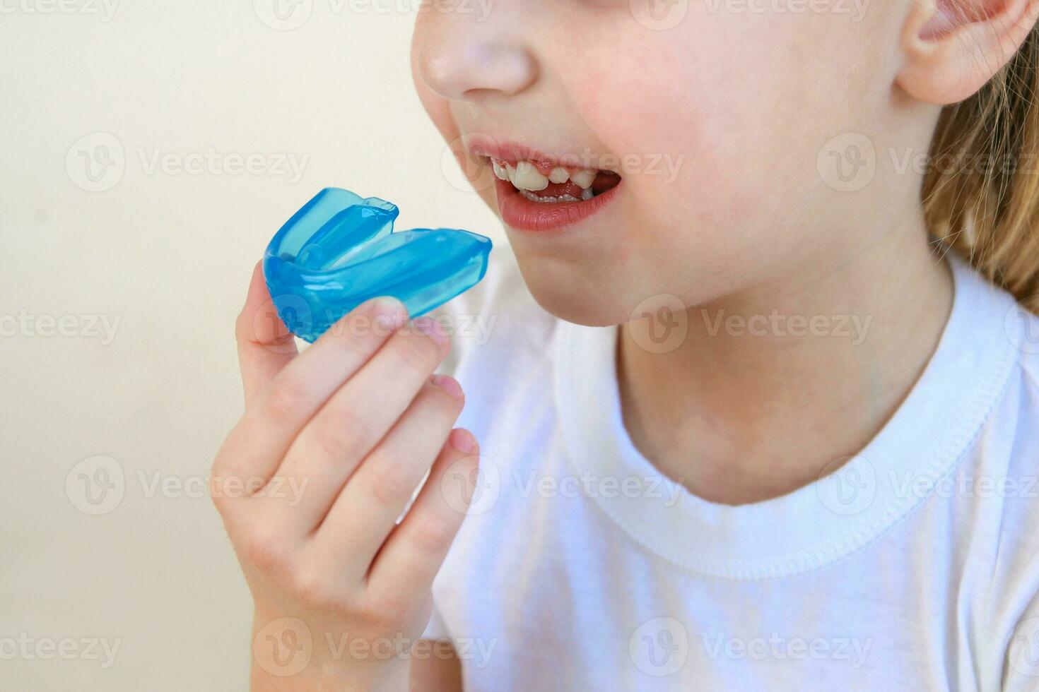 Dental simulator for teeth alignment . The child has mouth guards on his teeth. photo