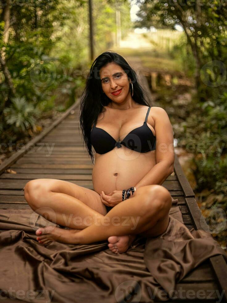 embarazada mujer posando en naturaleza foto