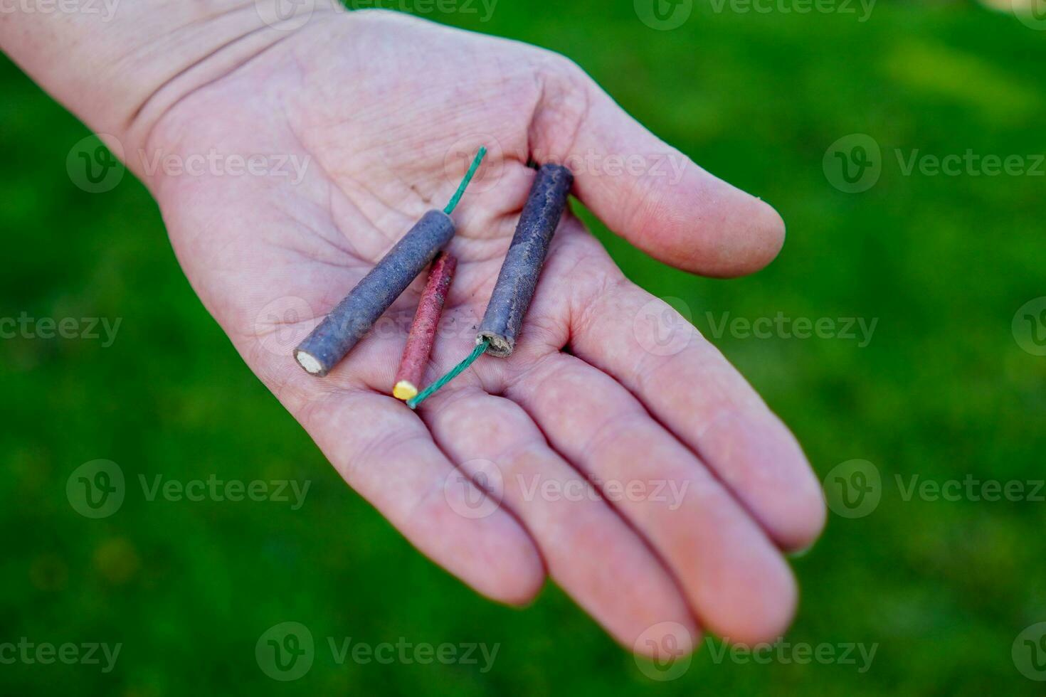 Firecrackers. Person holding firecrackers. Shooting firecrackers and fireworks. photo