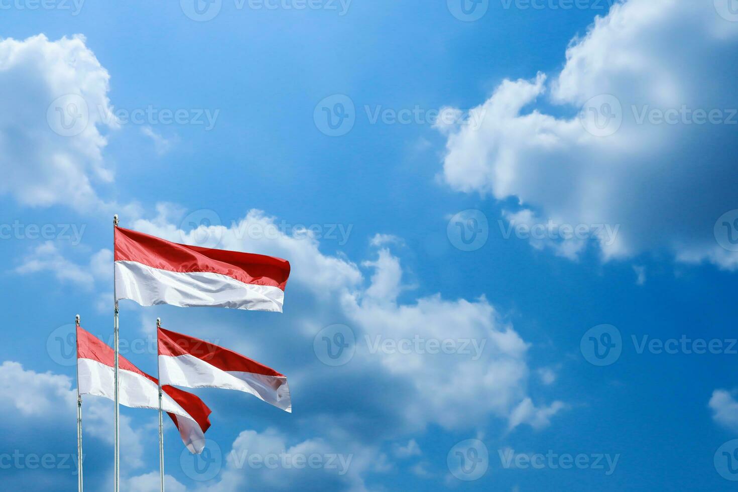 17 August 1945, Indonesian flags against sky background. Independence day concept photo