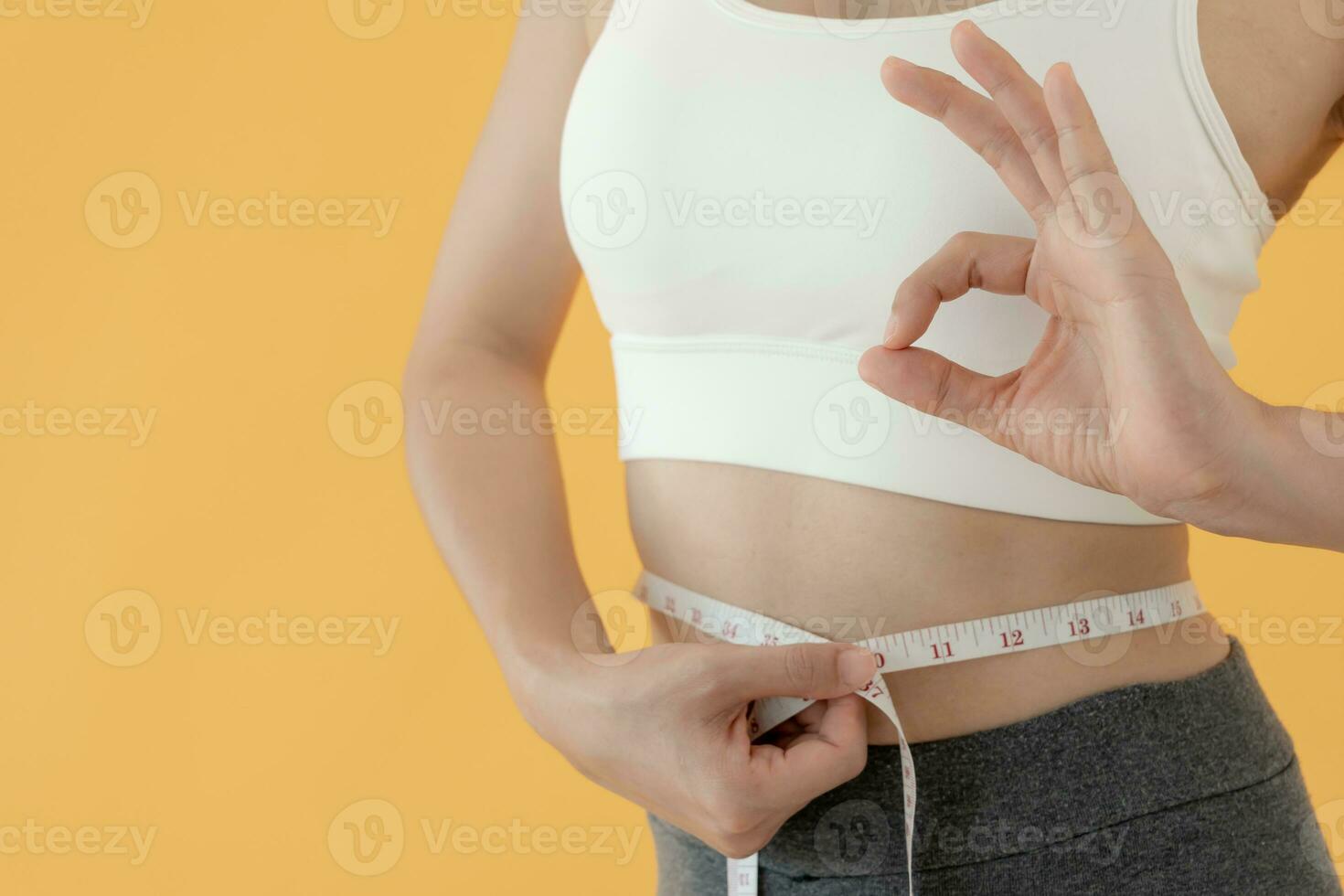 Diet and dieting. Beauty slim female body use tape measure. Woman in  exercise clothes achieves weight loss goal for healthy life, crazy about  thinness, thin waist, nutritionist. Fitness 25025259 Stock Photo at