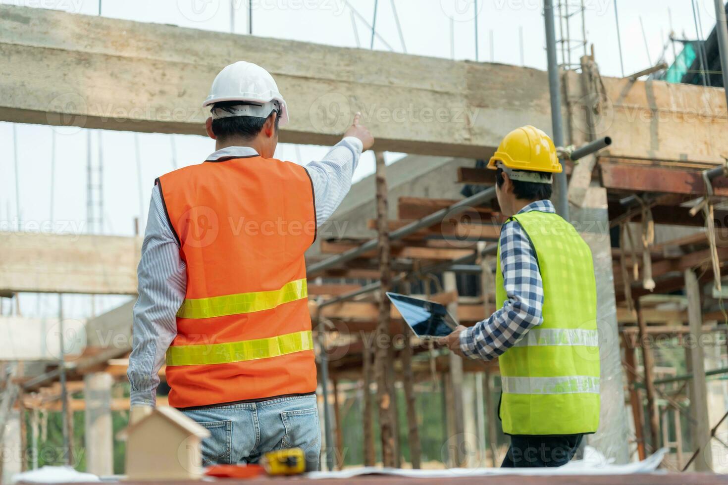 Engineers team use laptop and check the blueprint on site. Contractor and inspector inspection construction during project.civil Forman check quality assurance. Audit, inspect, quality control. photo