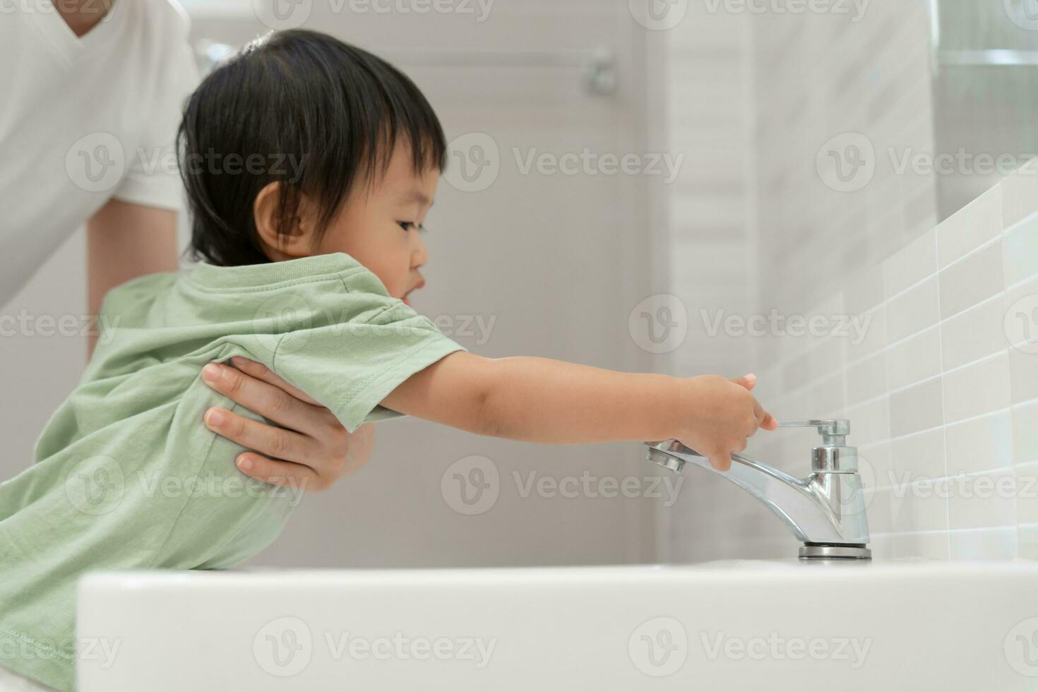 Save water. Little kid keeps turning off the running water in the bathroom to protect environment. Greening planet, reduce global warming, Save world, life, future, risk energy, crisis , water day. photo