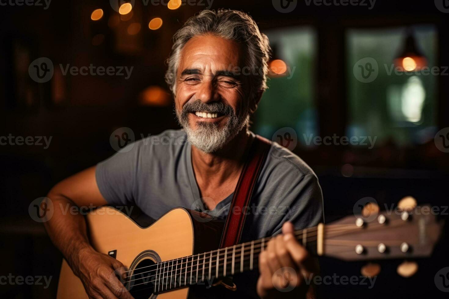 Mature Brazilian man playing guitar in a music room  photo with empty space for text