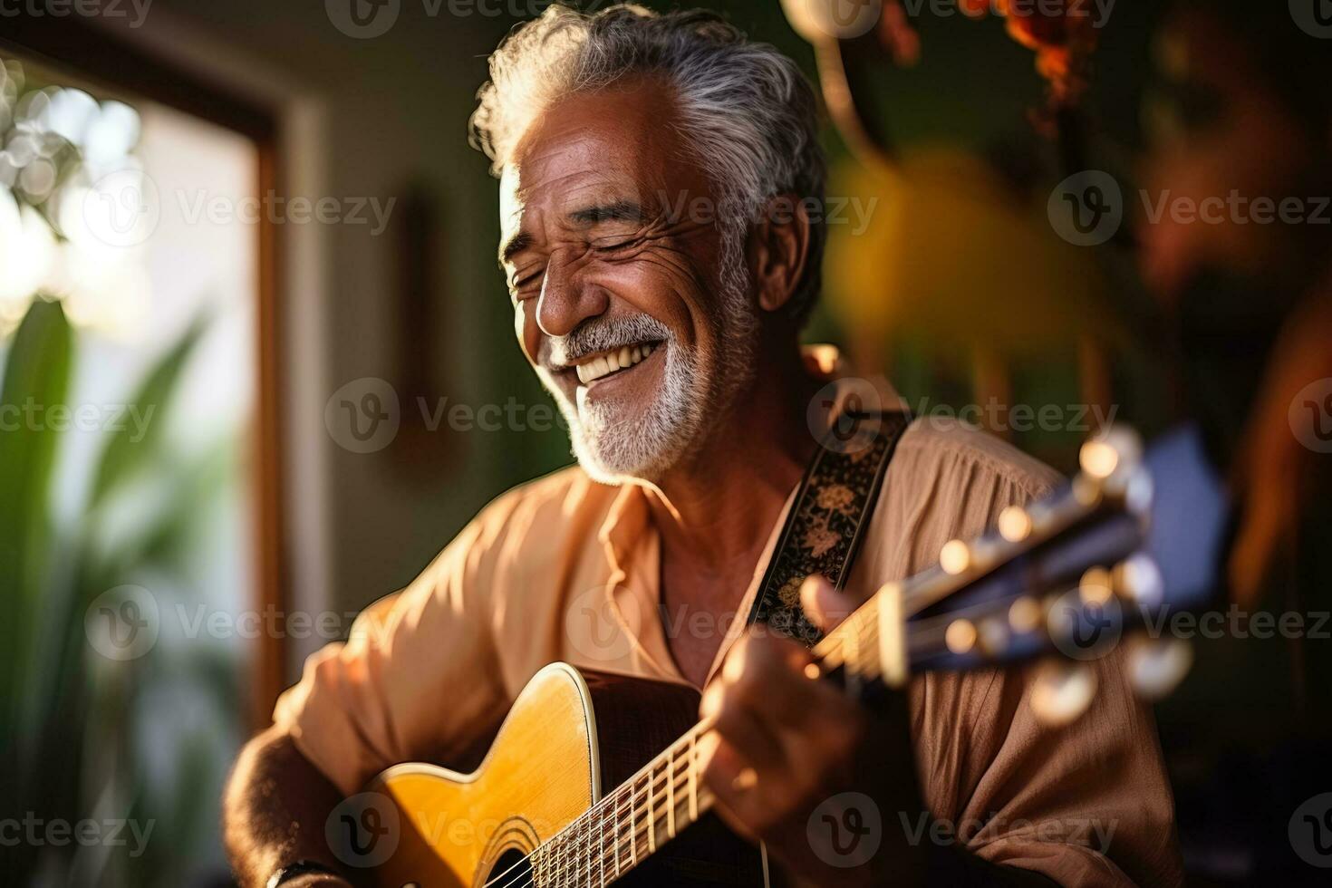 Mature Brazilian man playing guitar in a music room  photo with empty space for text