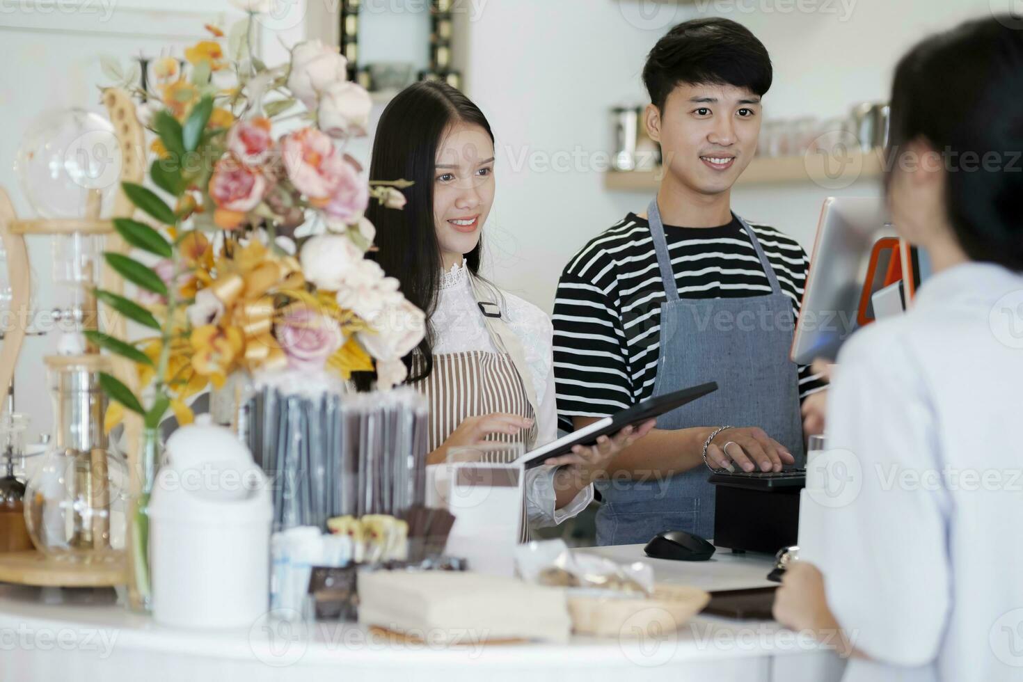 Asia Barista waiter take order from customer in coffee shop, cafe owner writing drink order at counter bar. photo