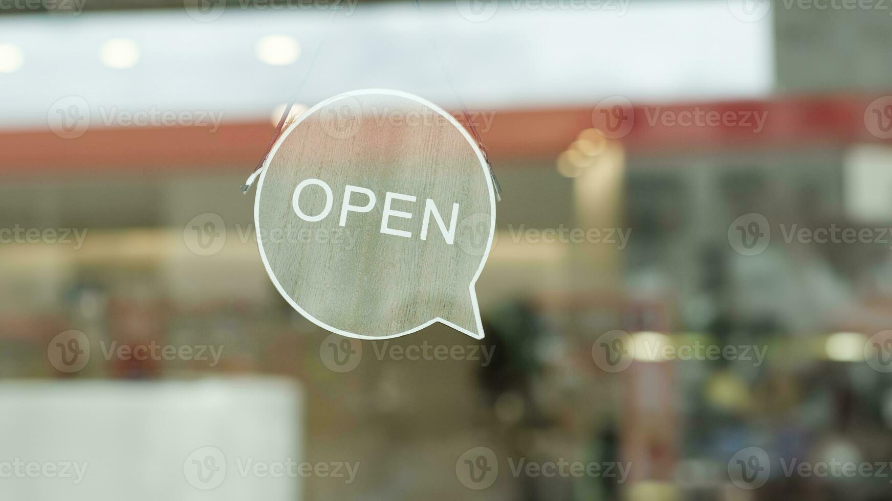 We are open sign hanging on the entrance door of a small cafe. photo