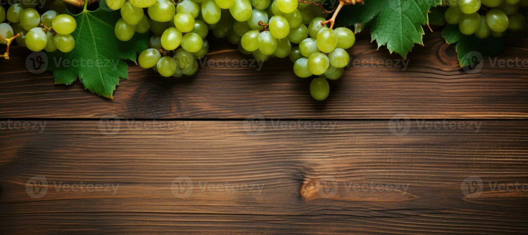 Green juicy grapes on wooden background. photo