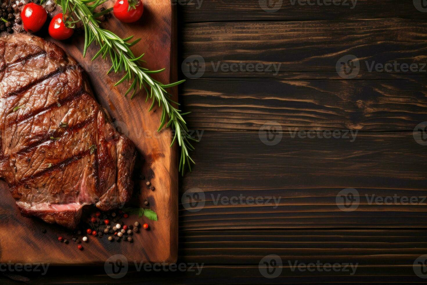Grilled meat barbecue steak on wooden cutting board with rosemary and copy space. Top view. photo