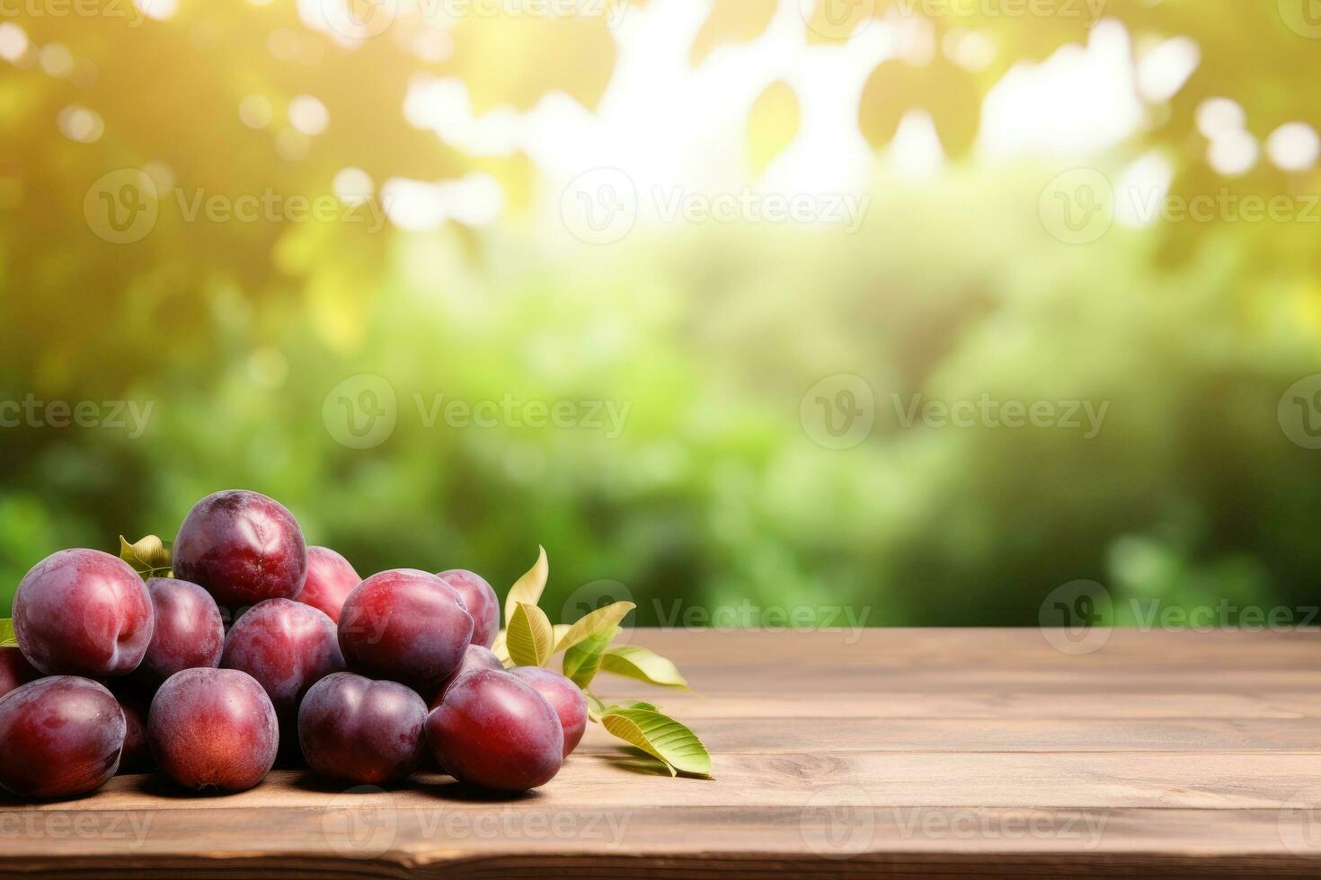 Wooden table top on blurred background of orchard with plums photo