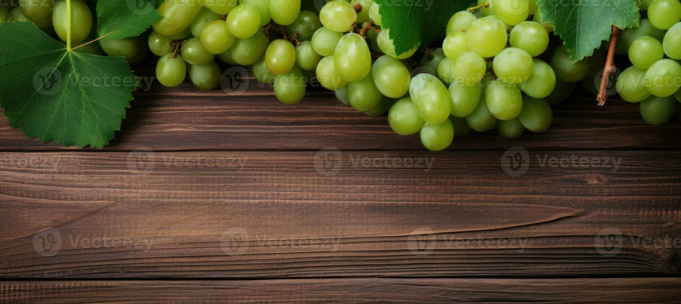 Green juicy grapes on wooden background. photo