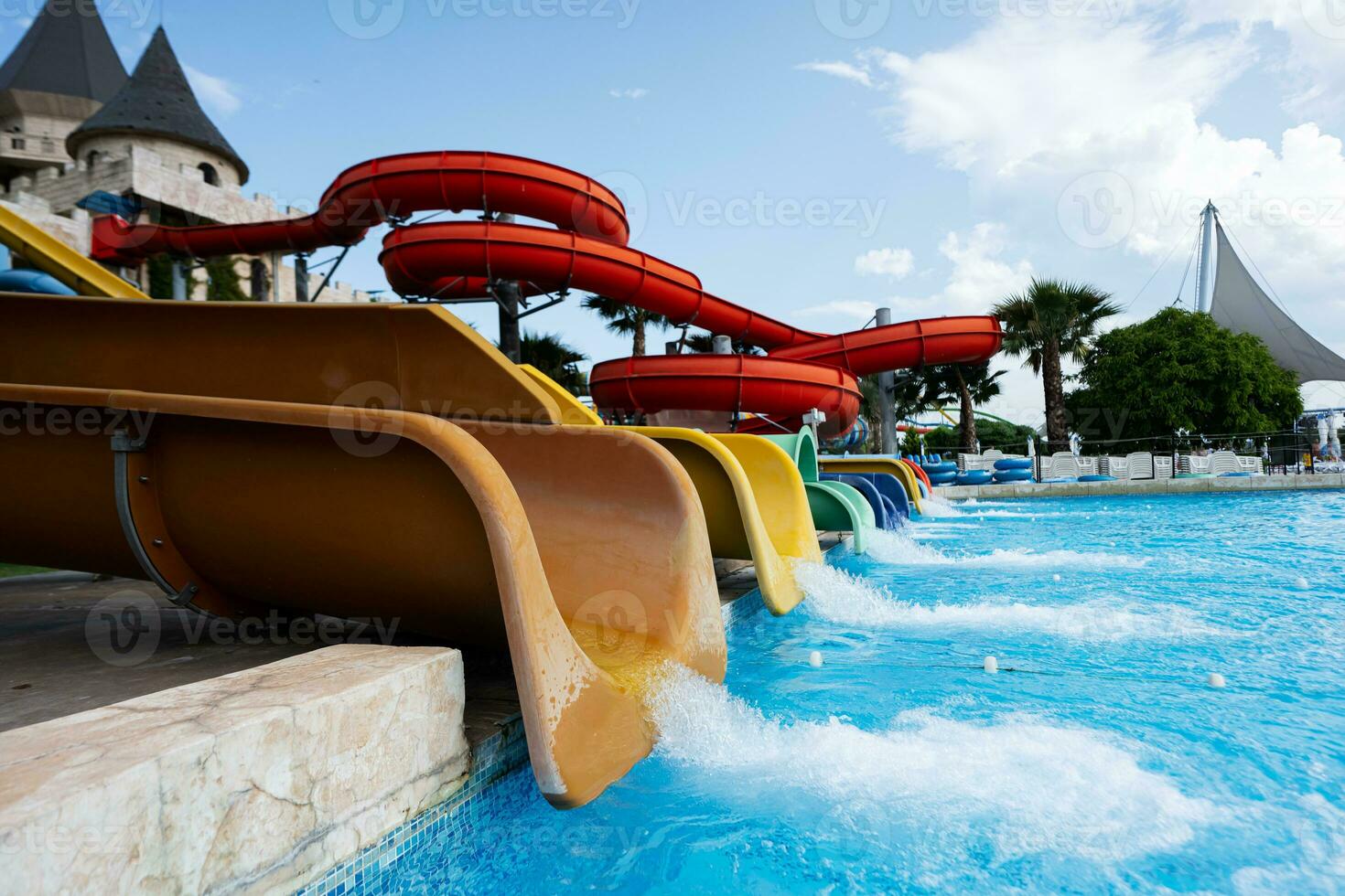 Colorful slides in the water park on a sunny summer day. photo