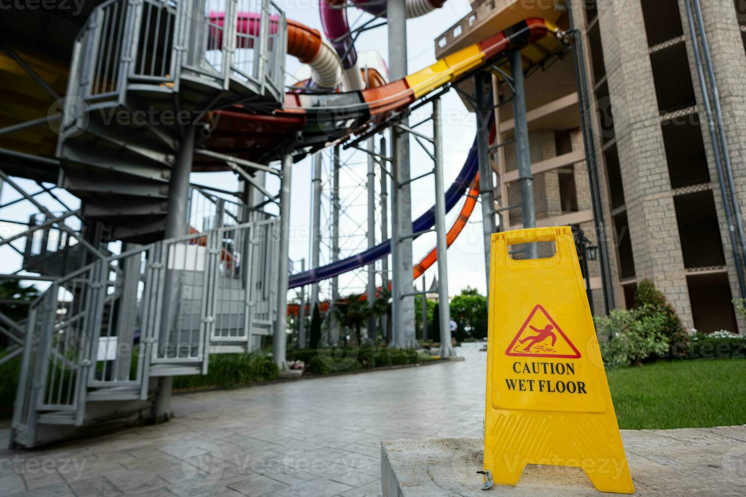 Caution sign in aqua park. Caution wet floor sign. photo