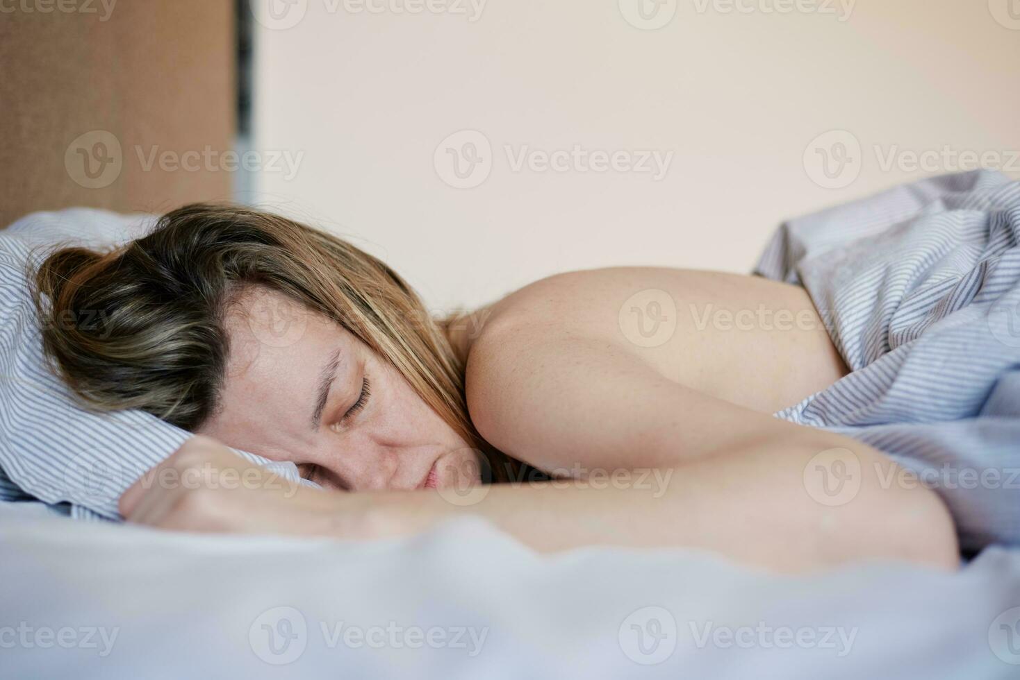 Woman sleeping in bed photo