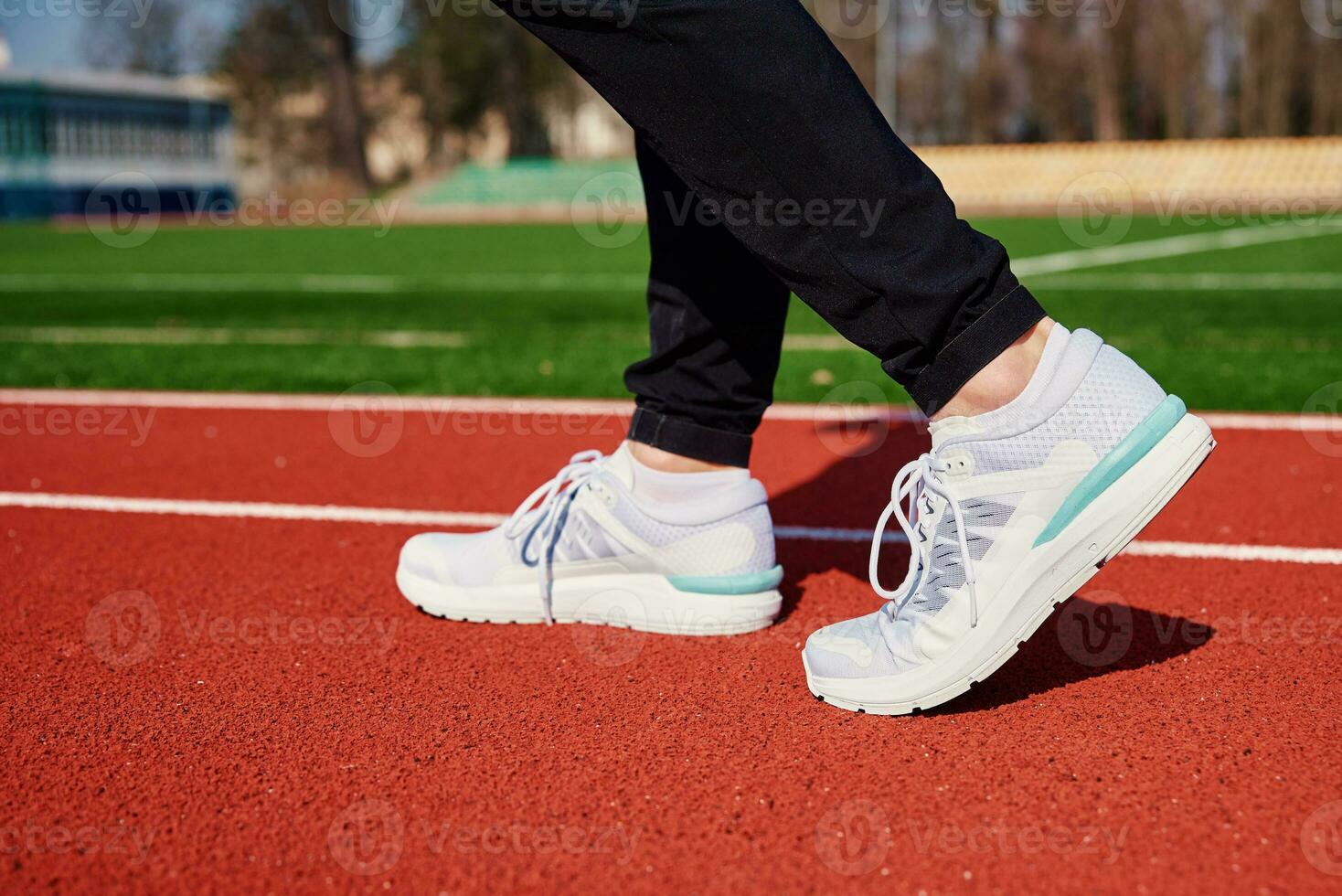 Runner feet running at sport stadium track photo