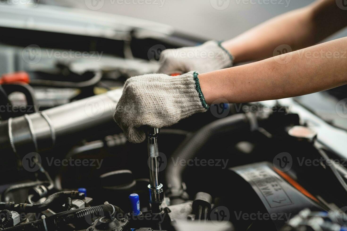 Concept of vehicle inspection and repair and maintenance services. Car maintenance, mechanic, mechanic, close-up, use wrench, repair, replace engine parts. Concepts of check and fix car and maintenanc photo