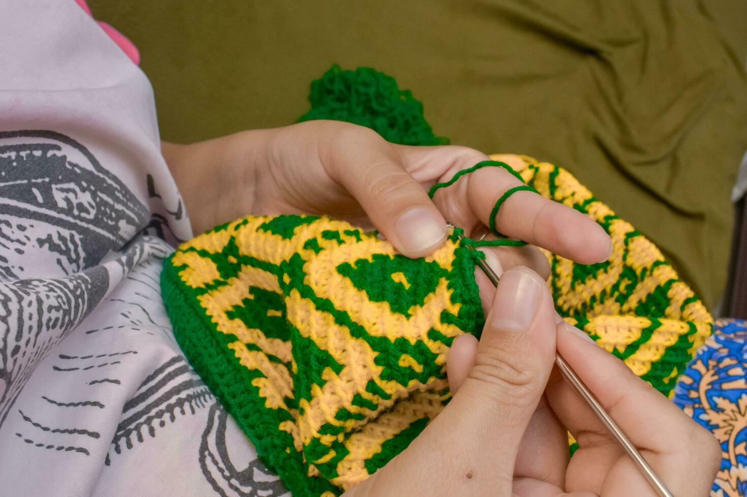 Kochet with green and yellow knitting thread photo