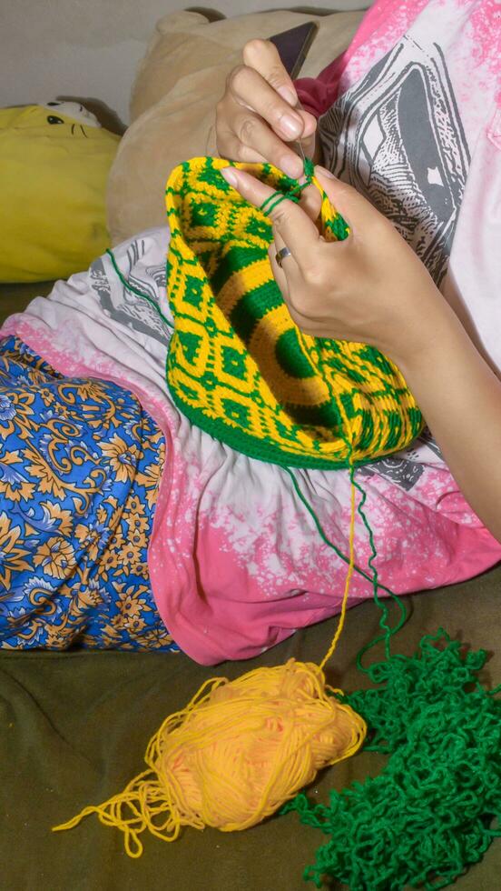 Kochet with green and yellow knitting thread photo