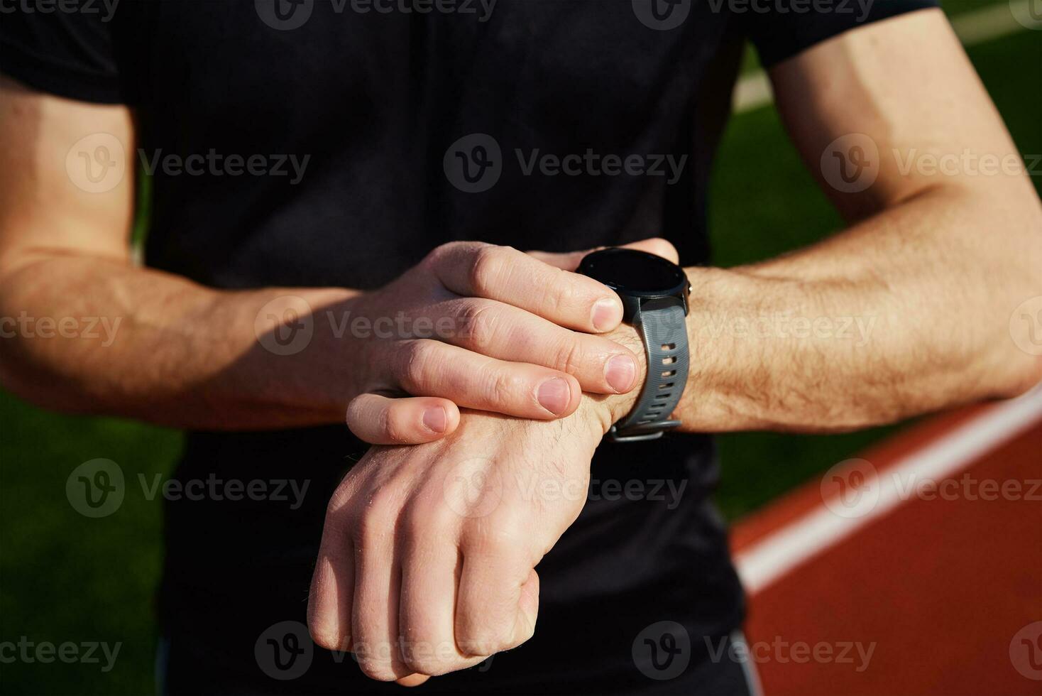 Man use fitness watch at stadium photo