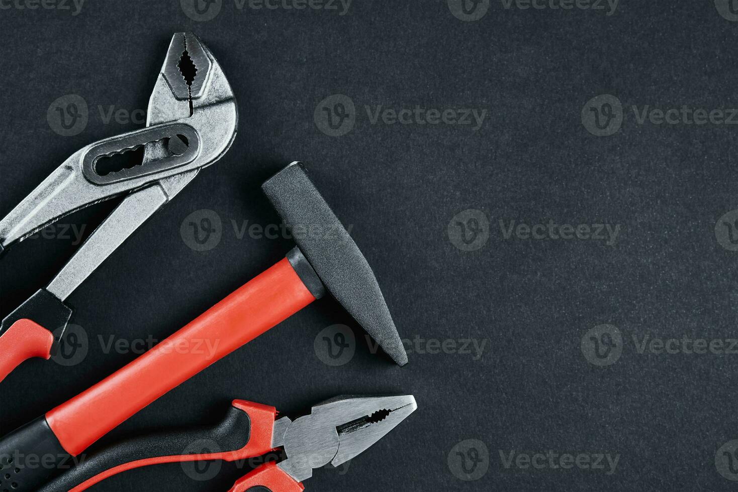 Set of tools for repair and maintenance on black background photo