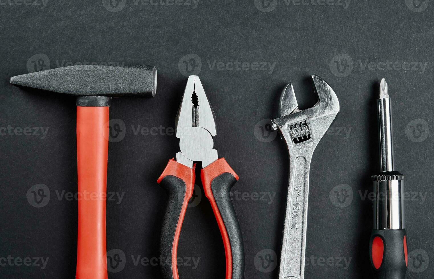 Set of tools for repair and maintenance on black background photo