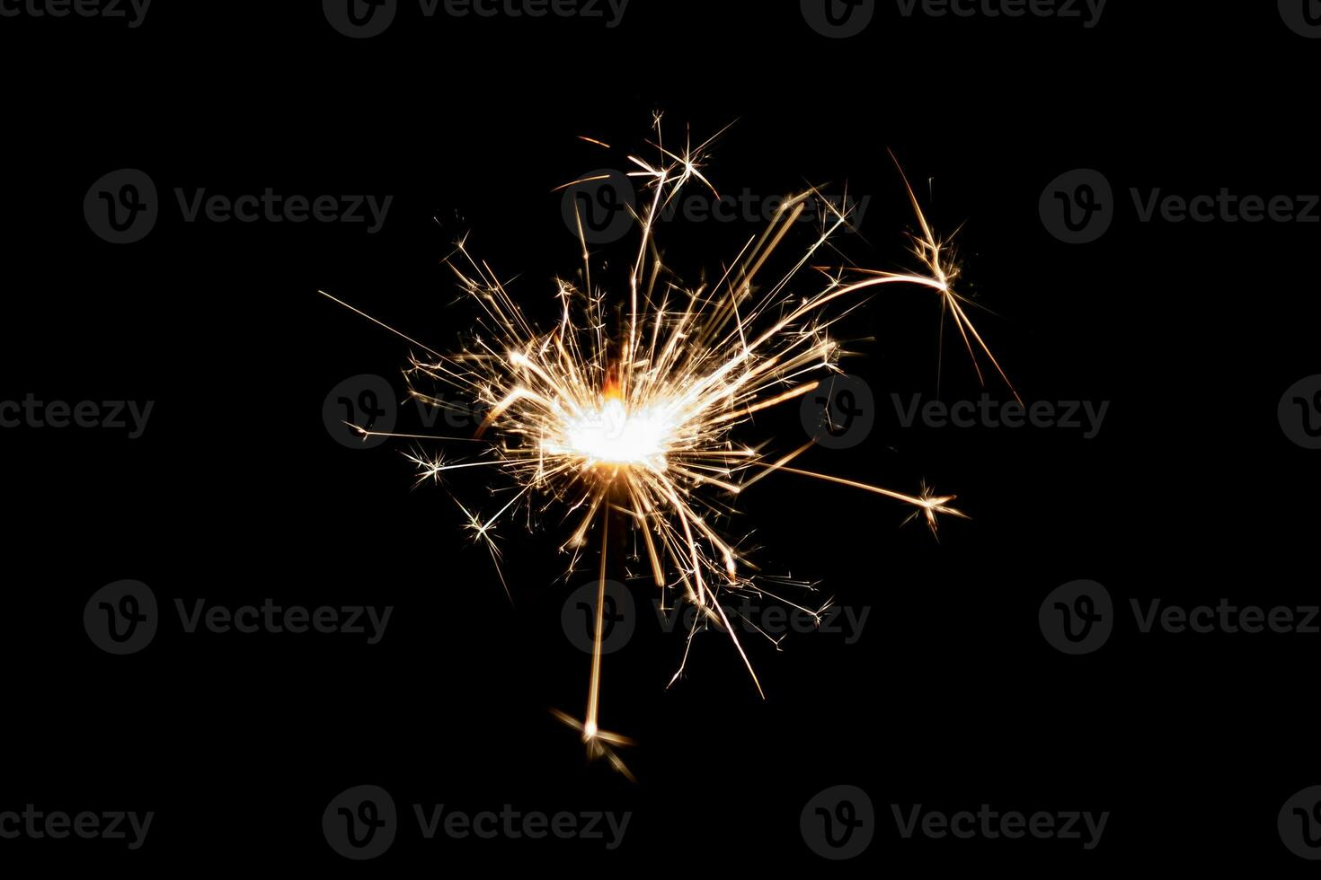 Burning sparkler isolated on black background. Fireworks theme. Light effect and texture. photo