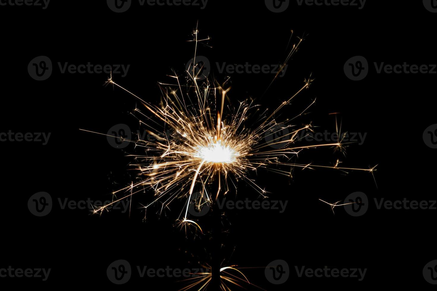 Burning sparkler isolated on black background. Fireworks theme. Light effect and texture. photo