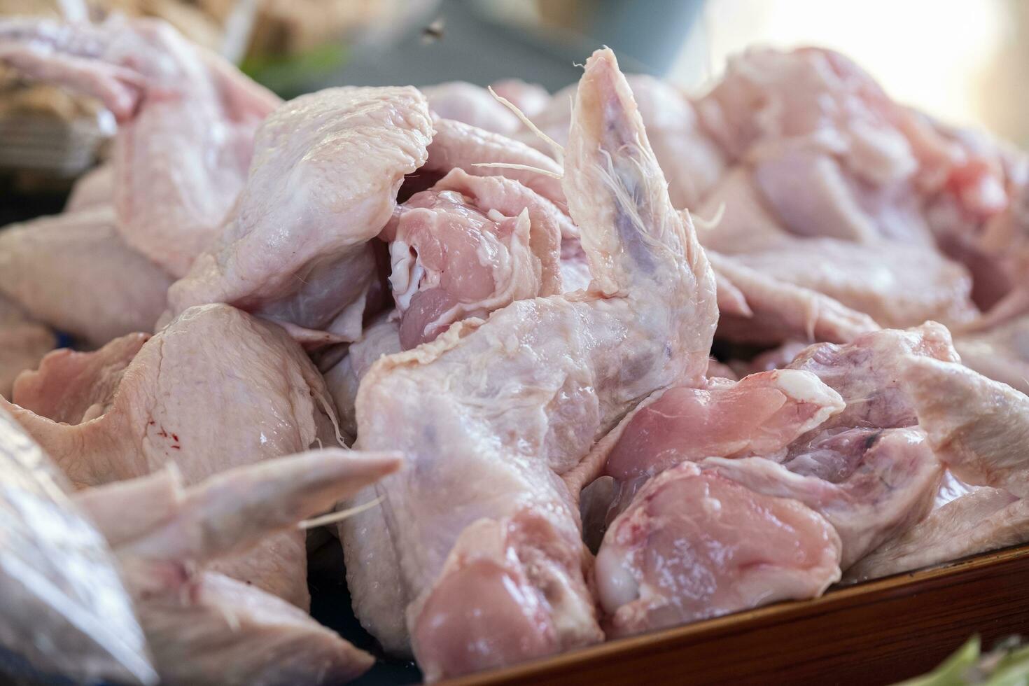 raw chicken pieces on a tray. chicken wings. healthy food. photo