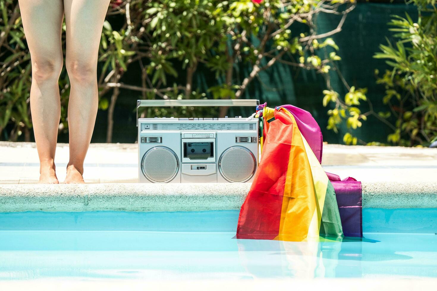 Group of friends sunbathing in the pool with old record player. lgtbi movement photo