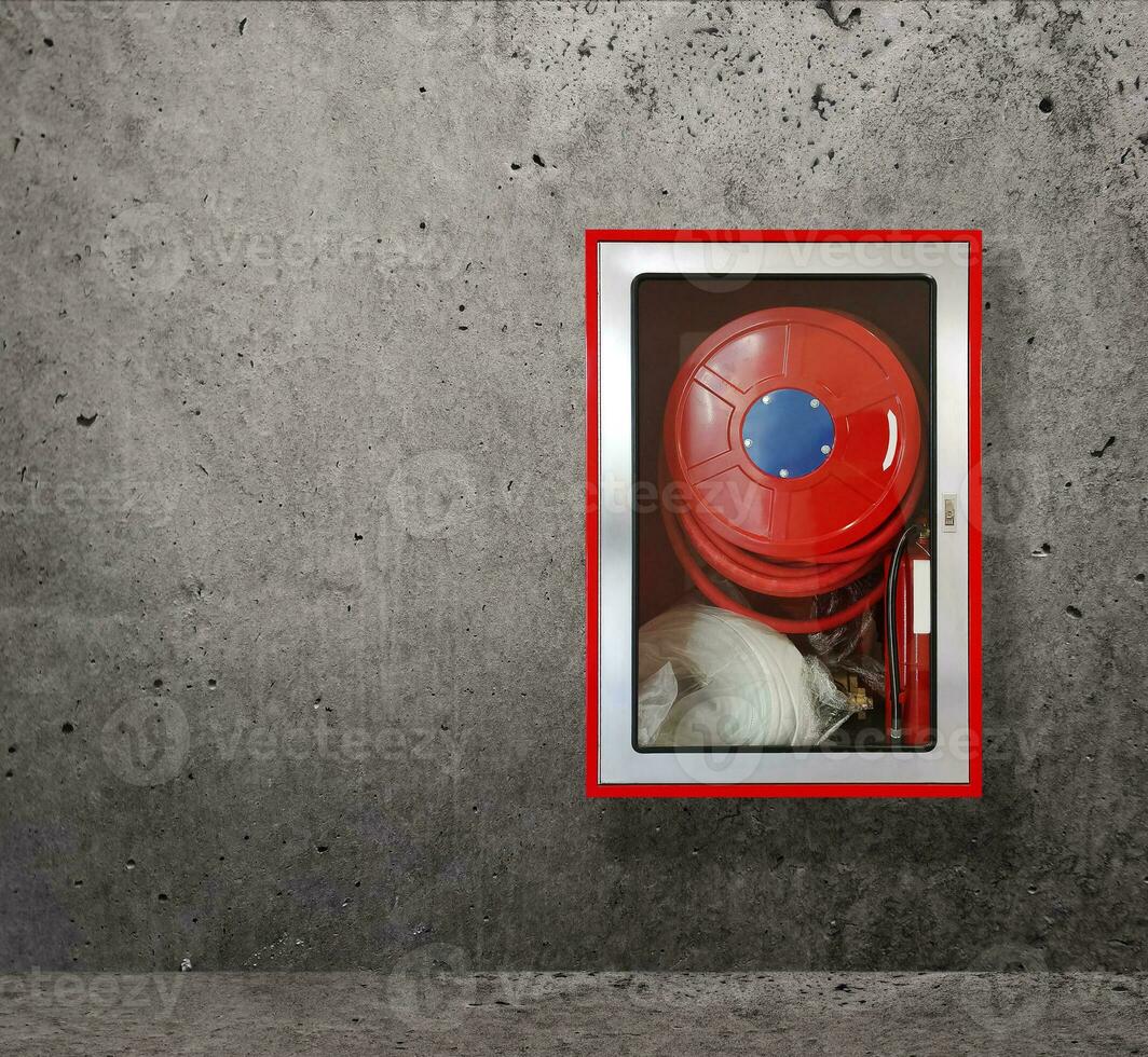 Fire extinguishers for fire protection on cement walls photo