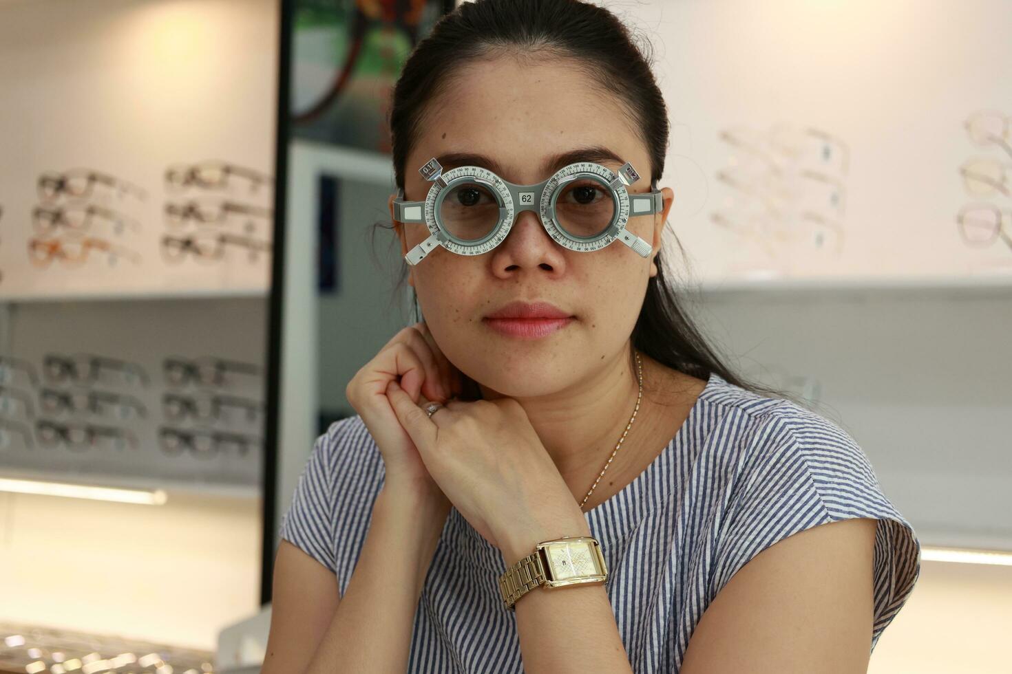 Eye exam concept woman eye test in clinic beautiful girl wearing Eye exam concept woman eye test in clinic beautiful girl wearing