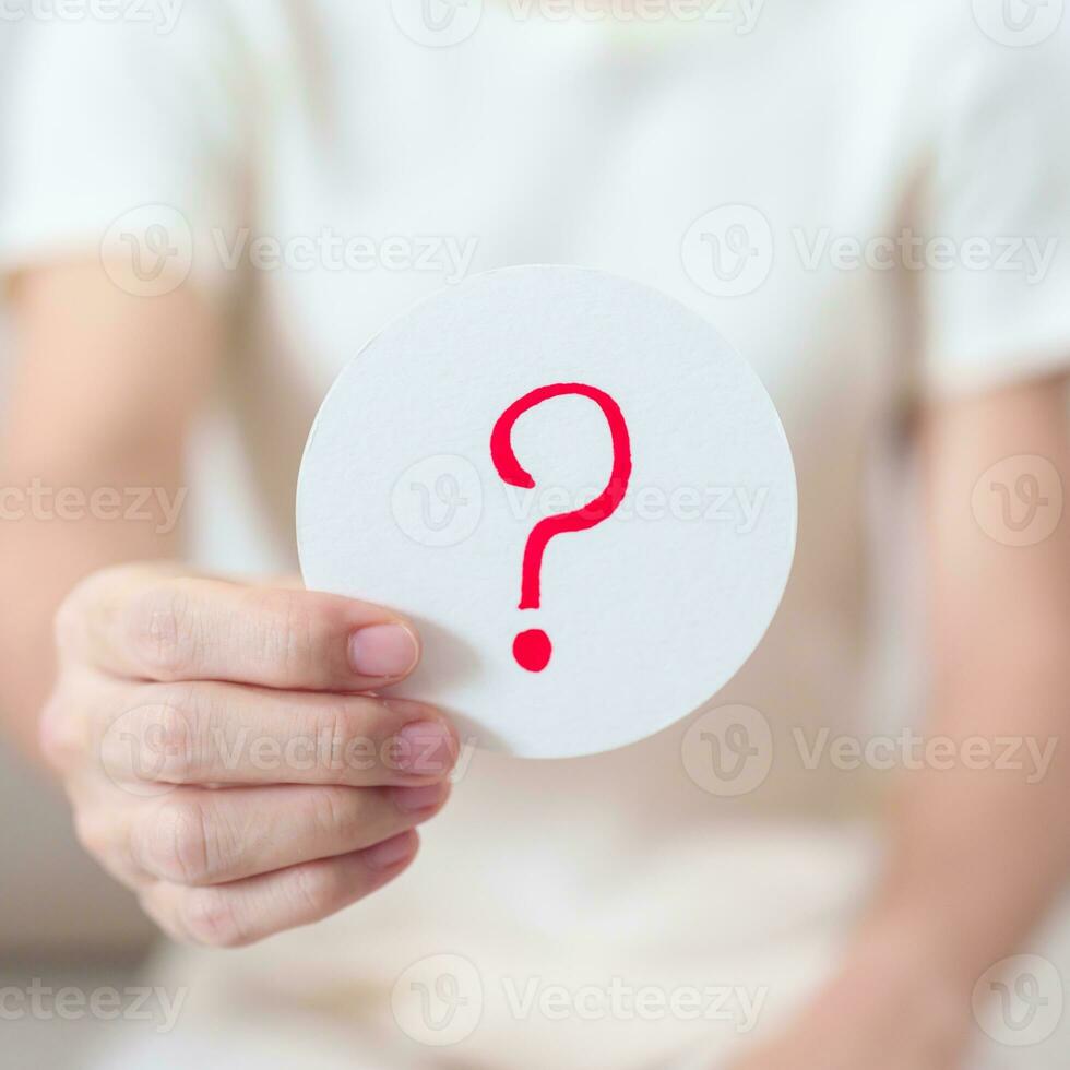 Woman show Questions Mark  on paper. FAQ, frequency asked questions, Answer, Q and A, Information, Communication and interrogation Concepts photo