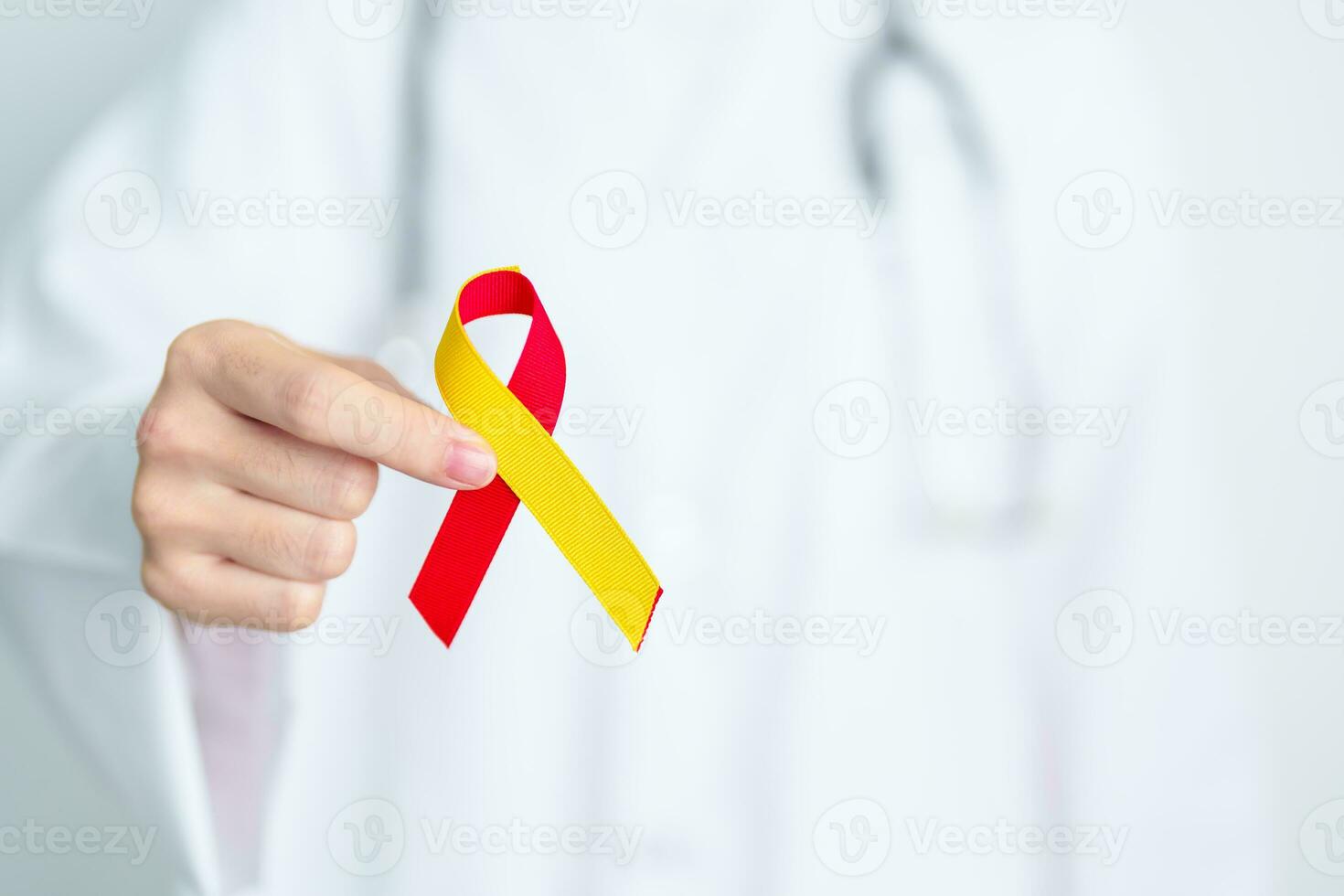 Doctor holding Red and Yellow ribbon. World hepatitis day awareness month, 28 July, Liver cancer, Jaundice, Cirrhosis, Failure, Enlarged, Hepatic Encephalopathy and Health concept photo