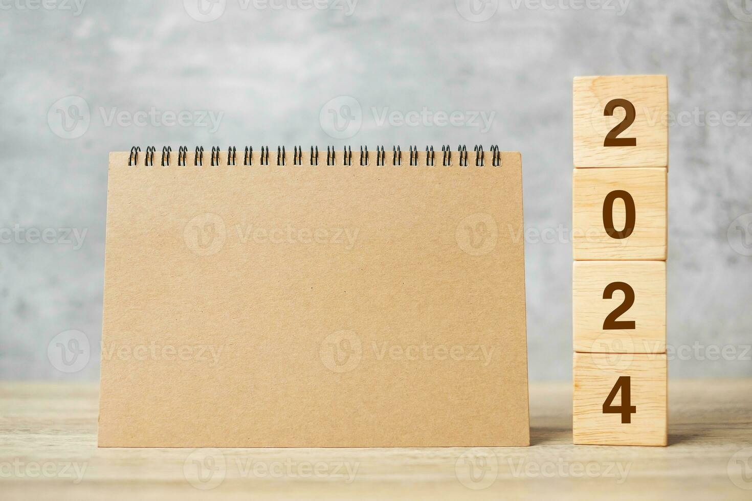 2024 Happy New Year with blank notebook and wooden number. countdown, Resolution, Goals, Plan, Action and Mission Concept photo