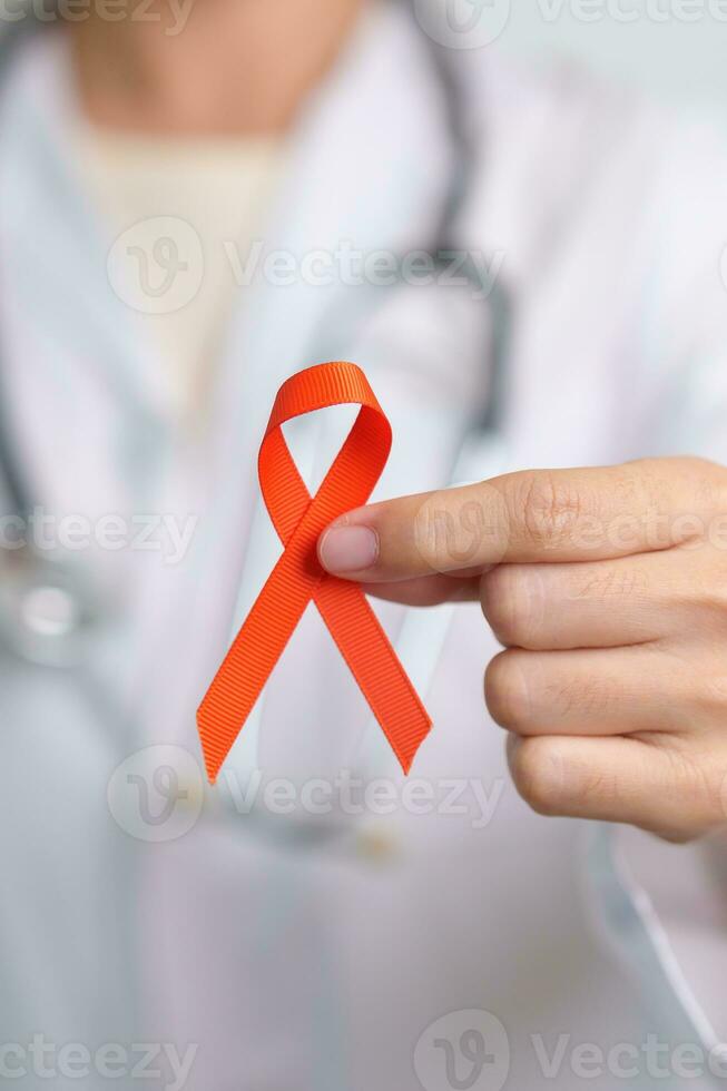 Orange Ribbon for Leukemia, Kidney cancer day, world Multiple Sclerosis, CRPS, Self Injury Awareness month. Healthcare and word cancer day concept photo