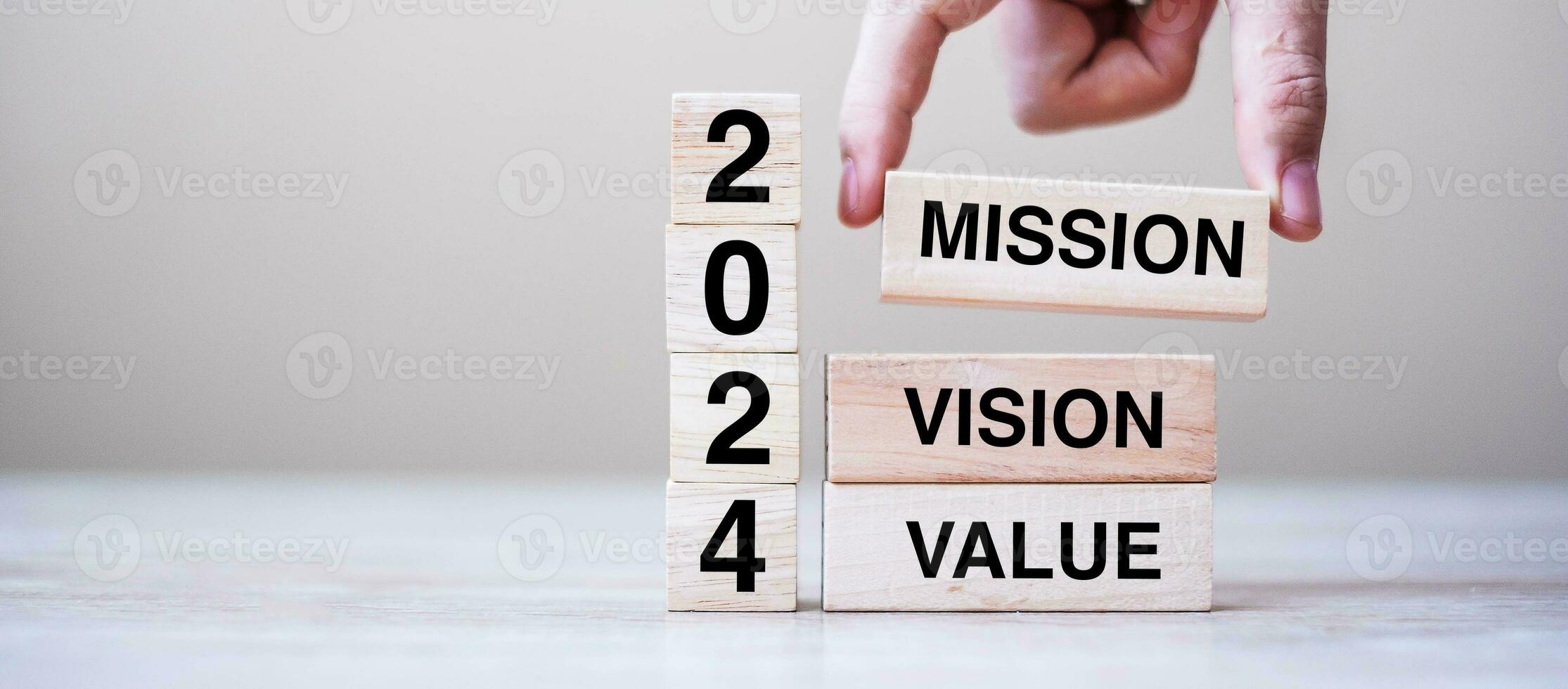 wooden block with text 2024 MISSION, VISION and VALUE on table background. Resolution, strategy, solution, goal, business and New Year holiday concepts photo
