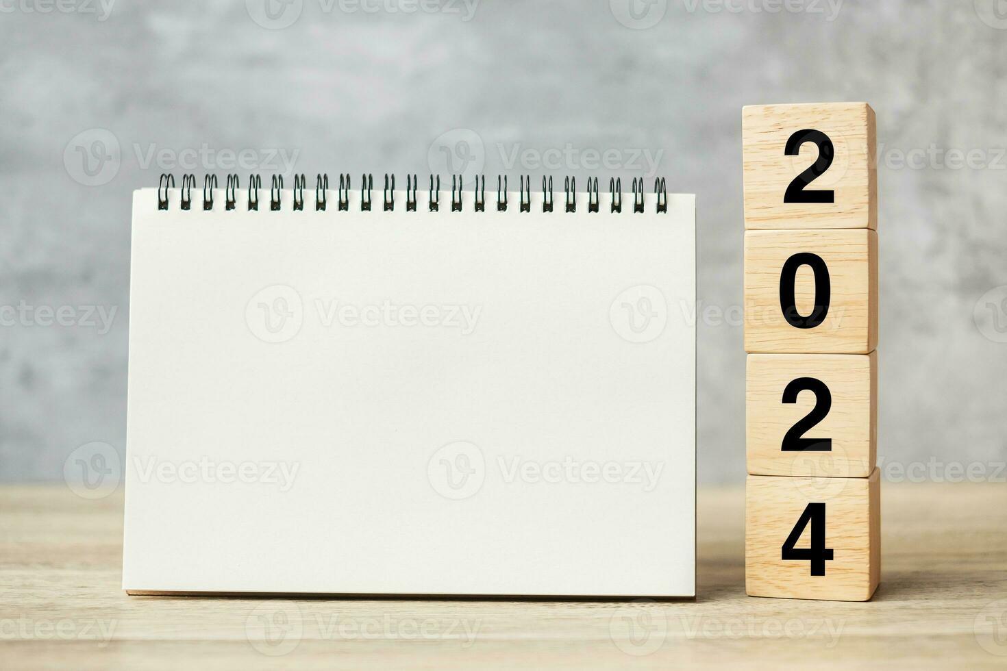 2024 Happy New Year with blank notebook and wooden number. countdown, Resolution, Goals, Plan, Action and Mission Concept photo
