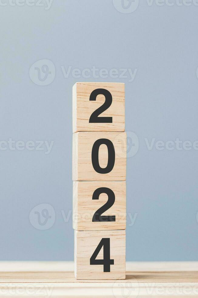 wooden cube block with 2024 text on table background. Resolution, plan, review, goal, start and New Year holiday concepts photo