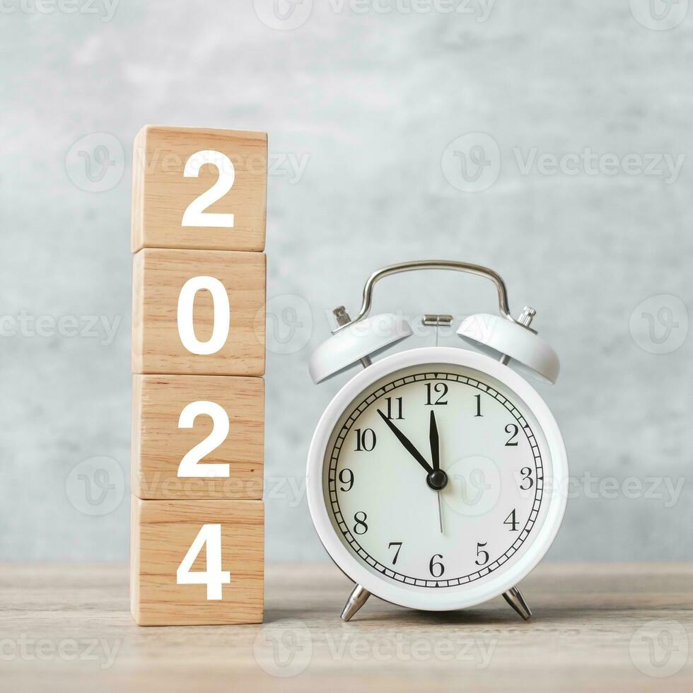 Happy New Year with vintage alarm clock and 2024 block. Christmas, New Start, Resolution, countdown, Goals, Plan, Action and Motivation Concept photo