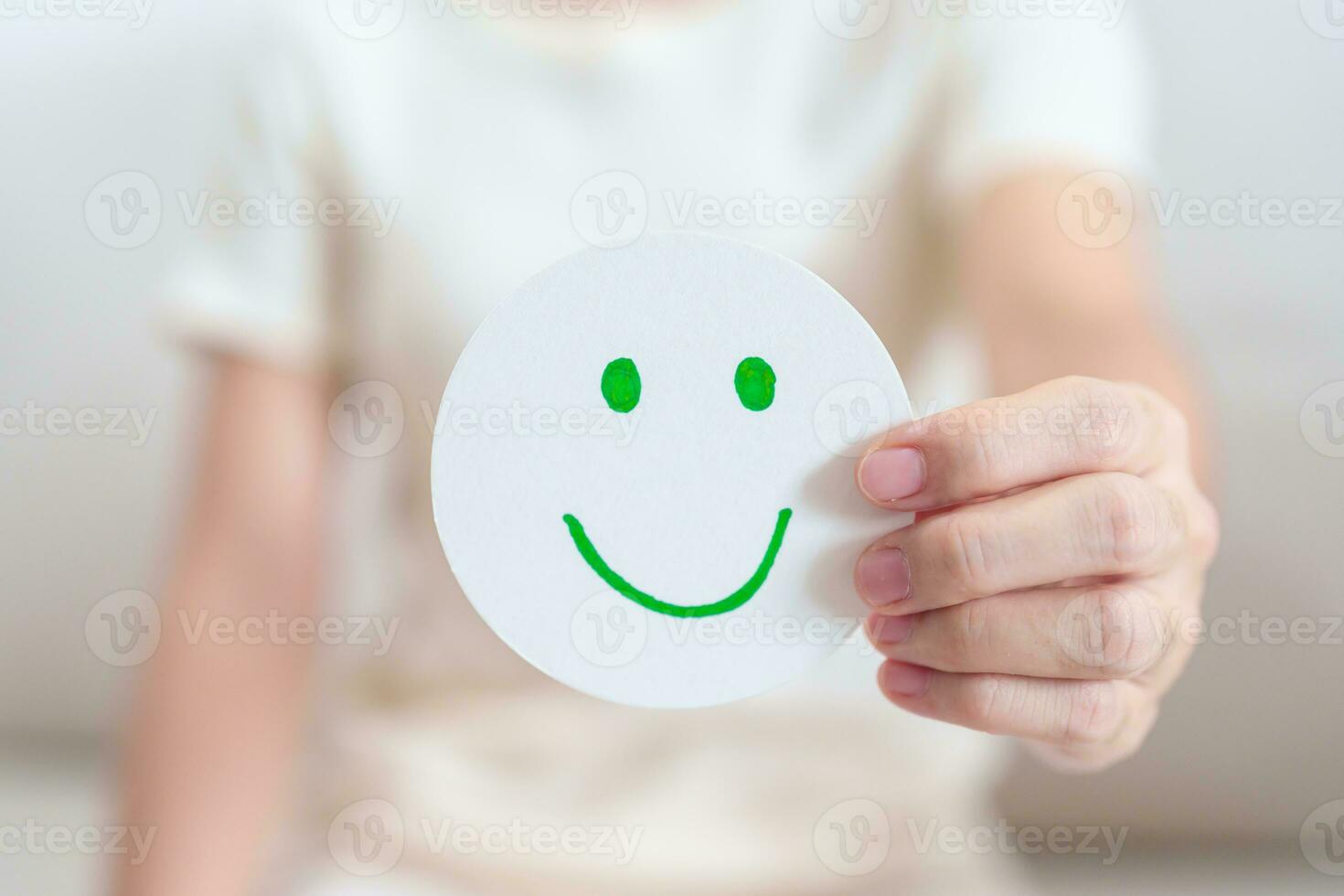 Woman show Happy Smile face paper, Mental health Assessment, Psychology, Health Wellness, Feedback, Customer Review, Experience, Satisfaction Survey, Positive Thinking and World Mental Health day photo