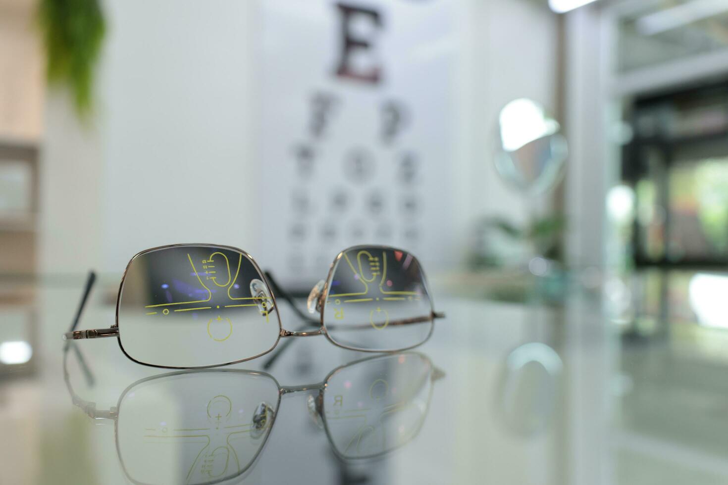 Closeup of eyeglass in optical store, glasses on the glass in clinic photo
