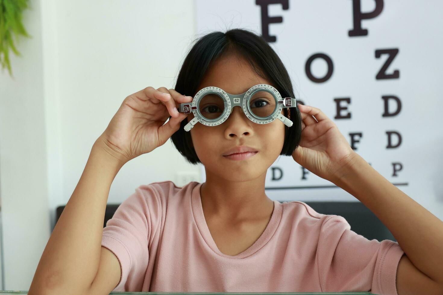 Eye care, Child wearing glasses in the optical store, kid eye test, children eye check, eye exam