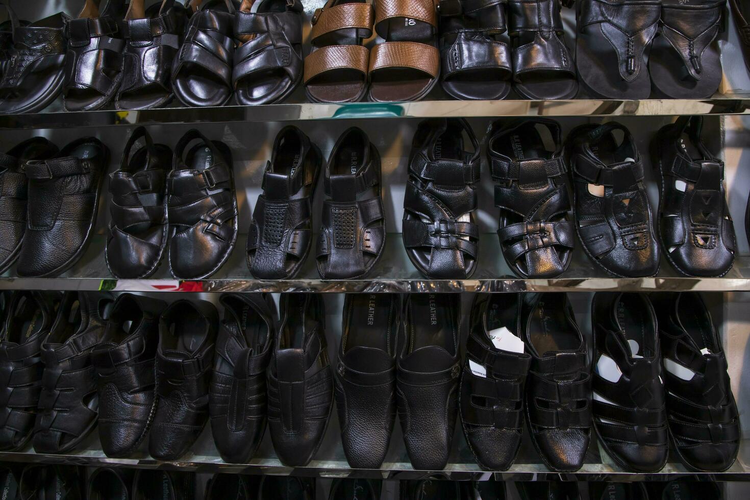21th July 2023, Dhaka, Badda, notun bazar.   Lather Shoes Showcase  on retail Shop Shelves for sale in Bangladesh photo