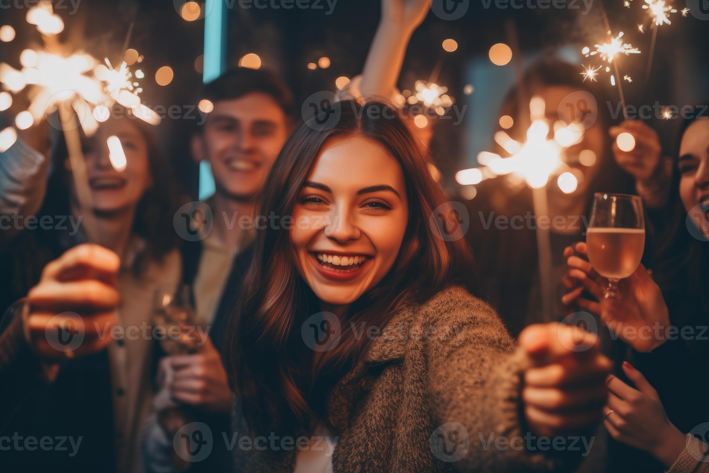 Group of young girls and boys friends celebrate New Year's Eve with 