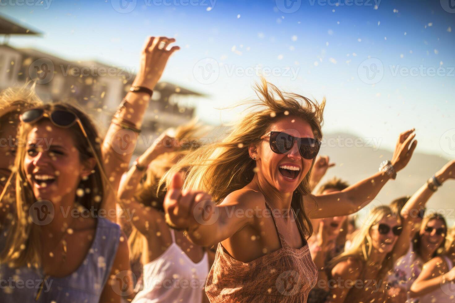 Beach club party, with people dancing and enjoying the music under the warm sun. photo