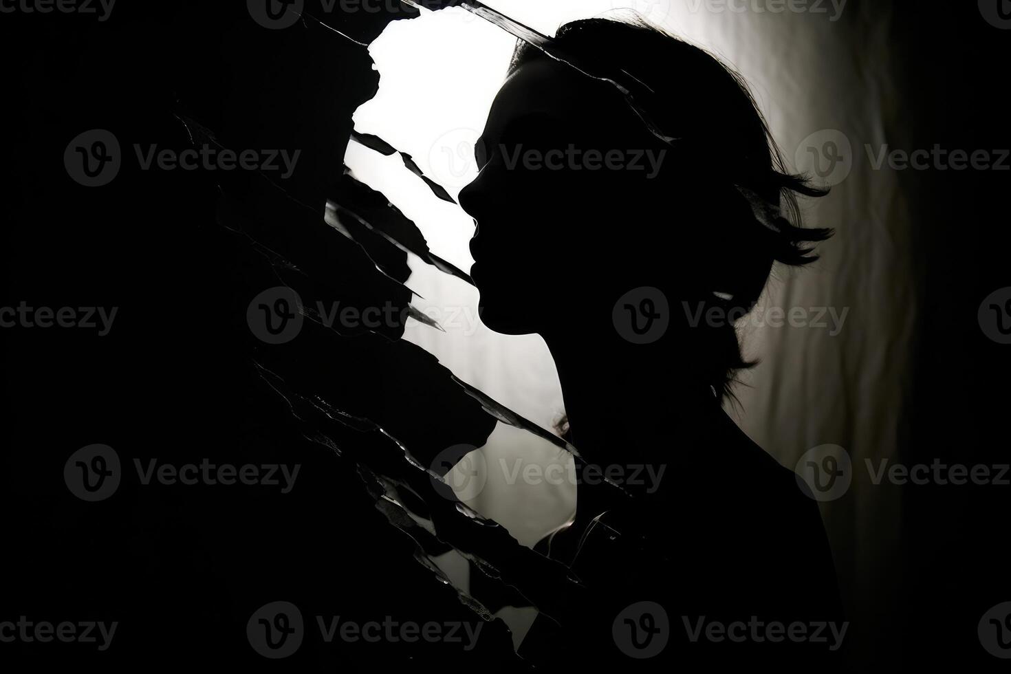 A silhouette of a head, half filled with crumpled waste paper, the other half spilling onto the reflective surface below. A photograph depicting the feeling of anxiety. photo