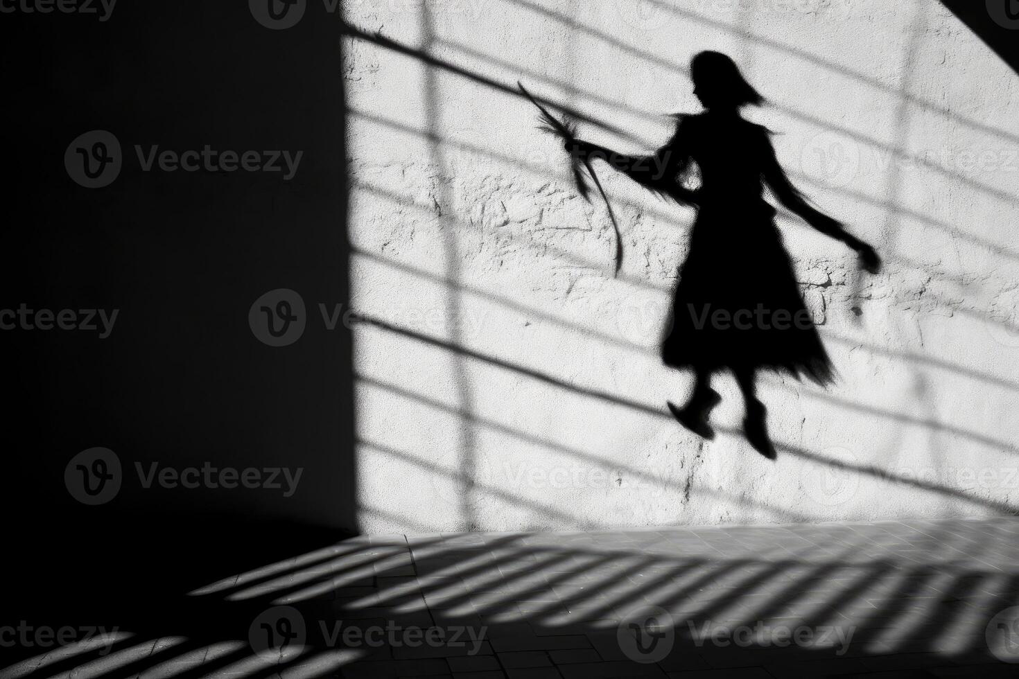 A witch's silhouette being cast on a wall, with the prominent shadow of a broomstick suggesting flight.  Generative AI photo