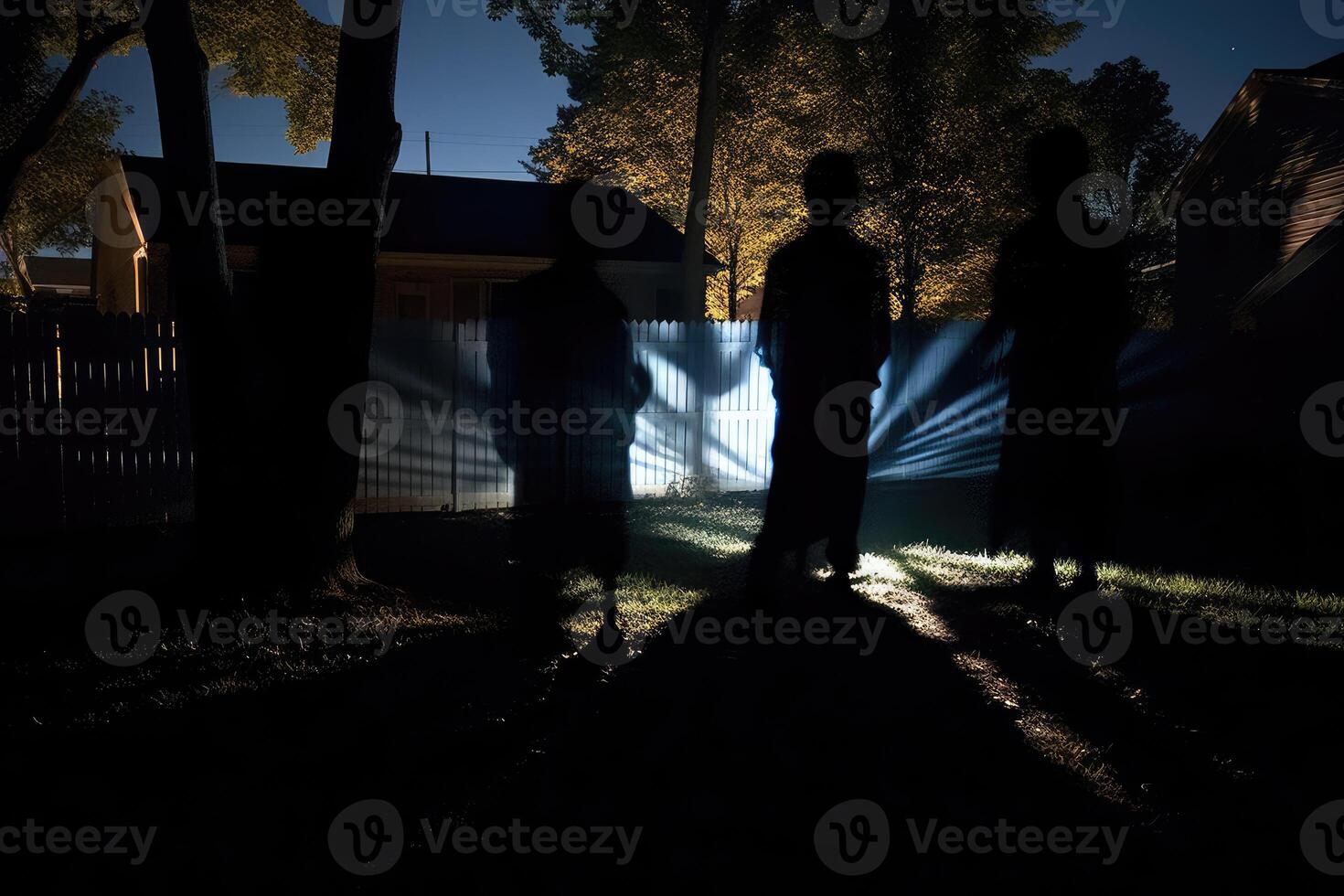 Eerie white ghosts made from sheets float in a moonlit backyard, casting long shadows. photo
