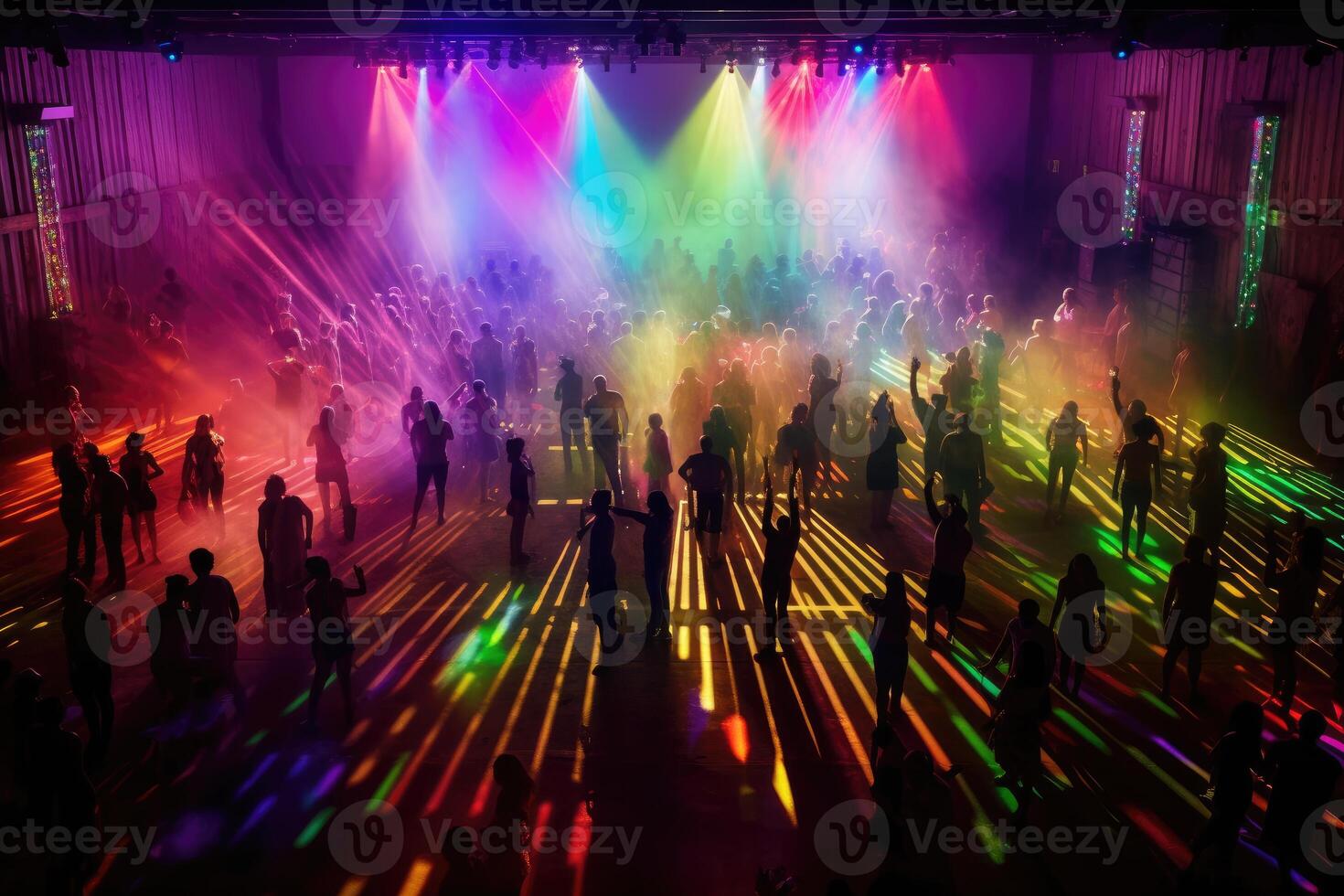 A Halloween party, their costumes silhouetted against the colorful, pulsing lights of a dance floor. photo